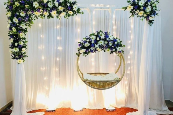 Star theme naming ceremony decoration with balloons and floral backdrop