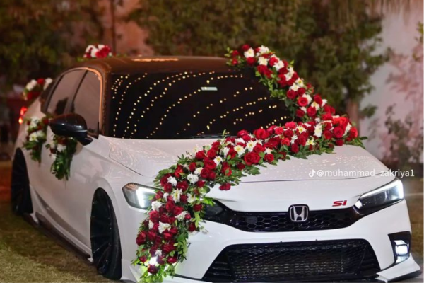 Premium wedding car decoration with roses and ribbons