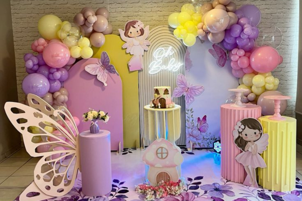 Whimsical Enchanted Wings stage with butterfly props and floral décor By Akshara Event