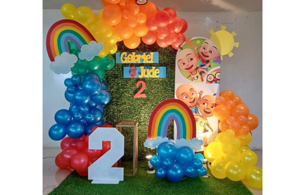 Colorful Coco Melon Jolly Jingles stage with balloons and character props